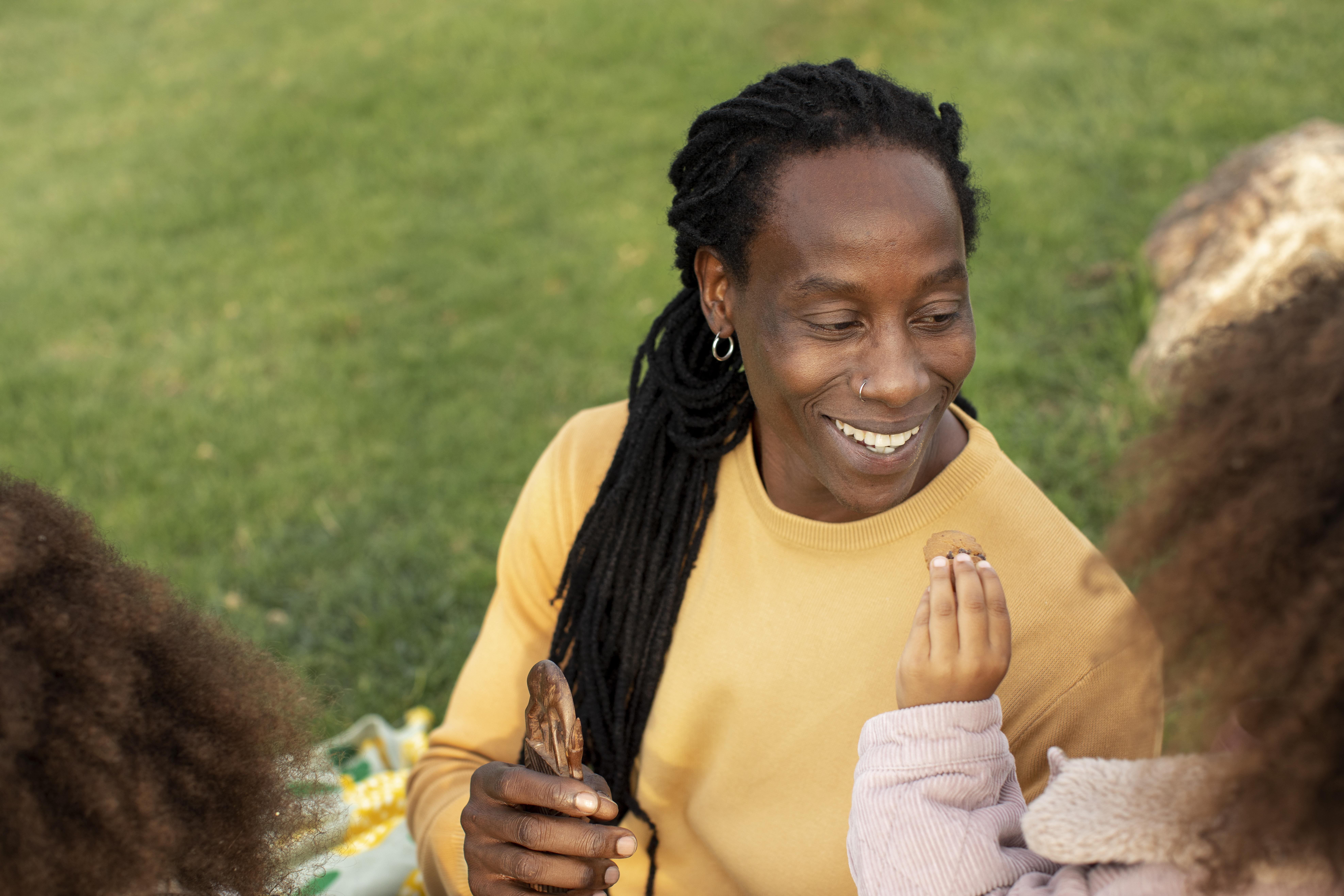 A joyful parent with children sharing a moment outdoors in nature