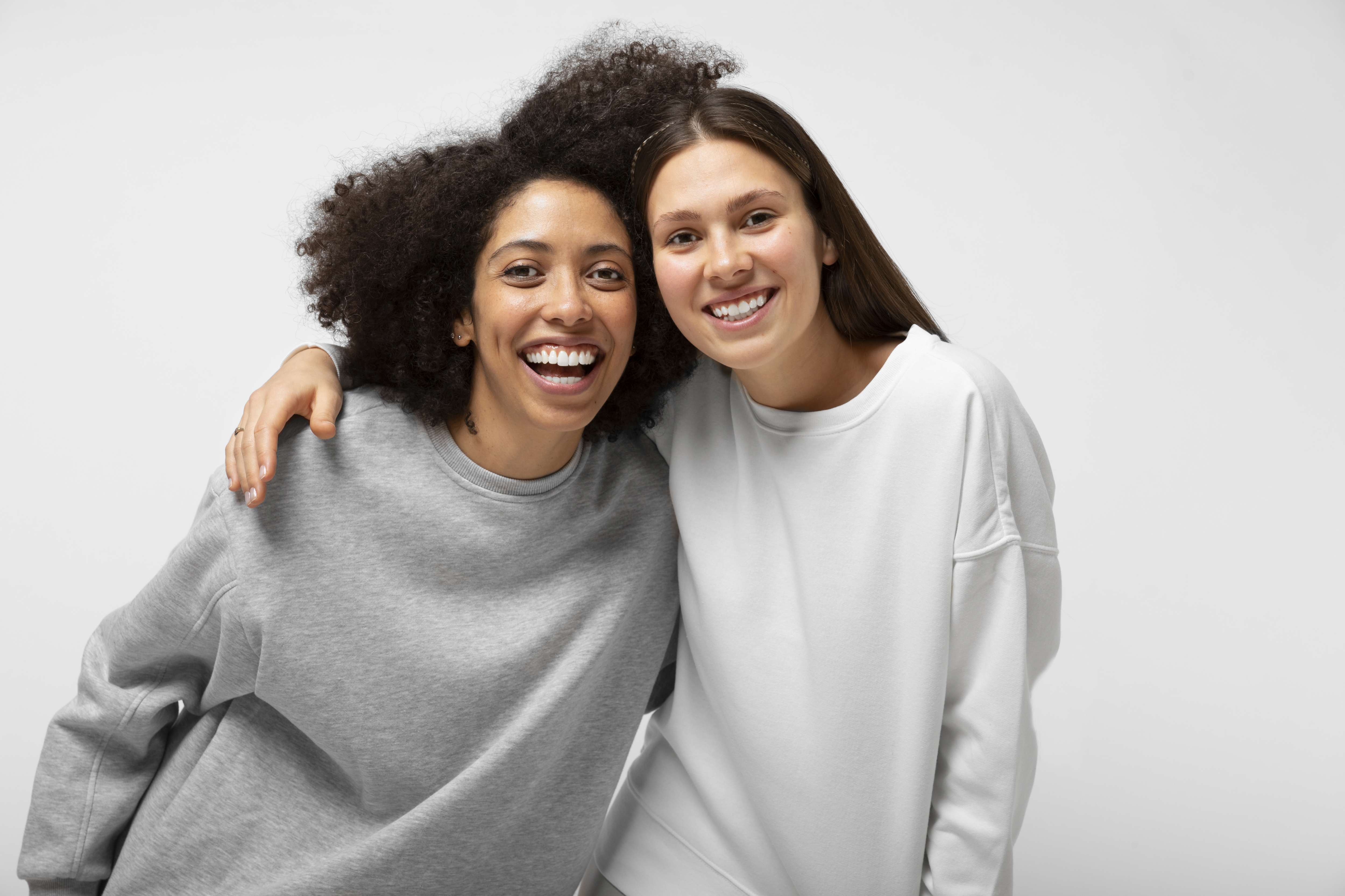Two smiling young adults together representing connection and support